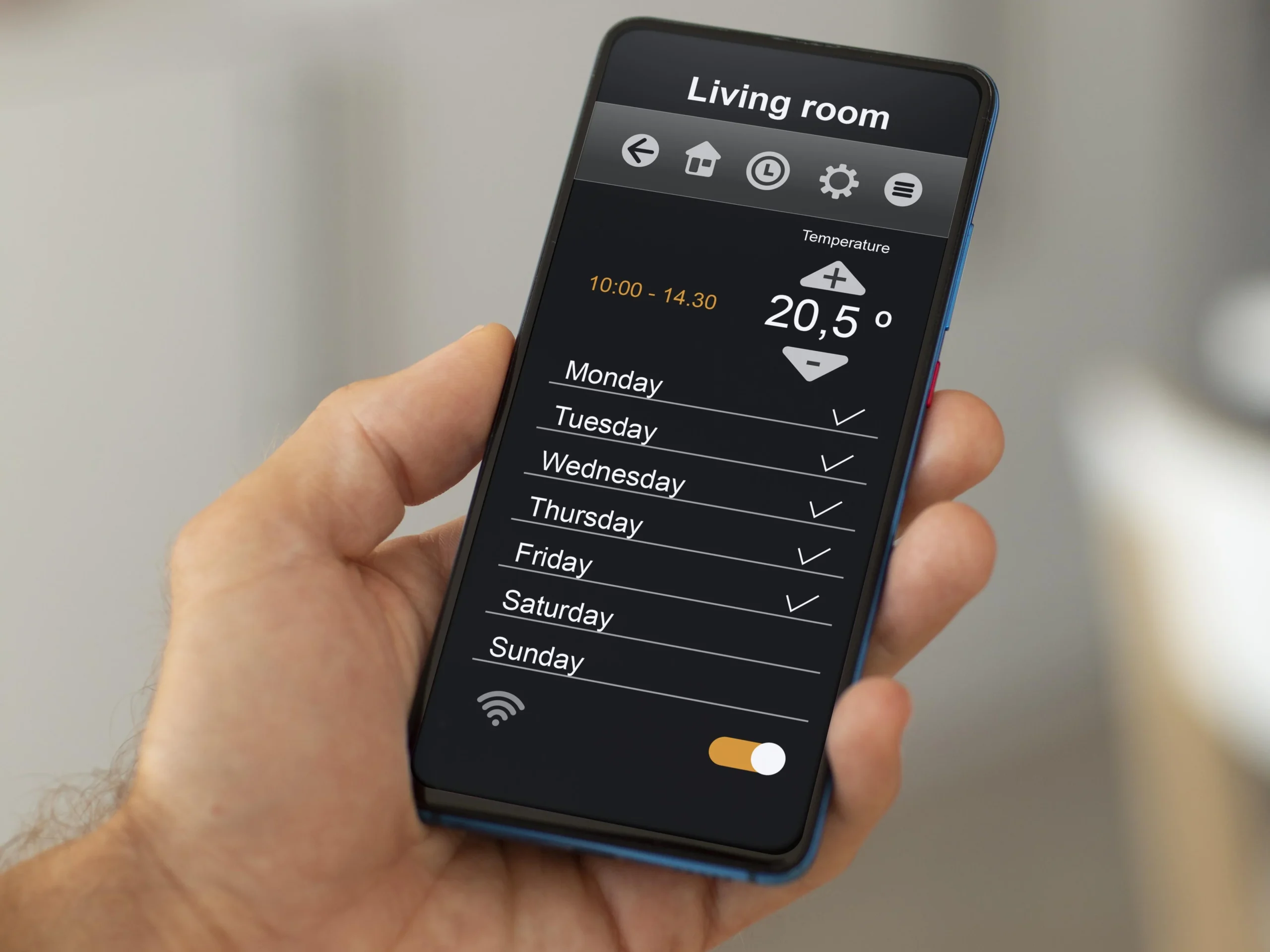 Homeowner-checking-real-time-energy-usage-on-smart energy-monitor-app