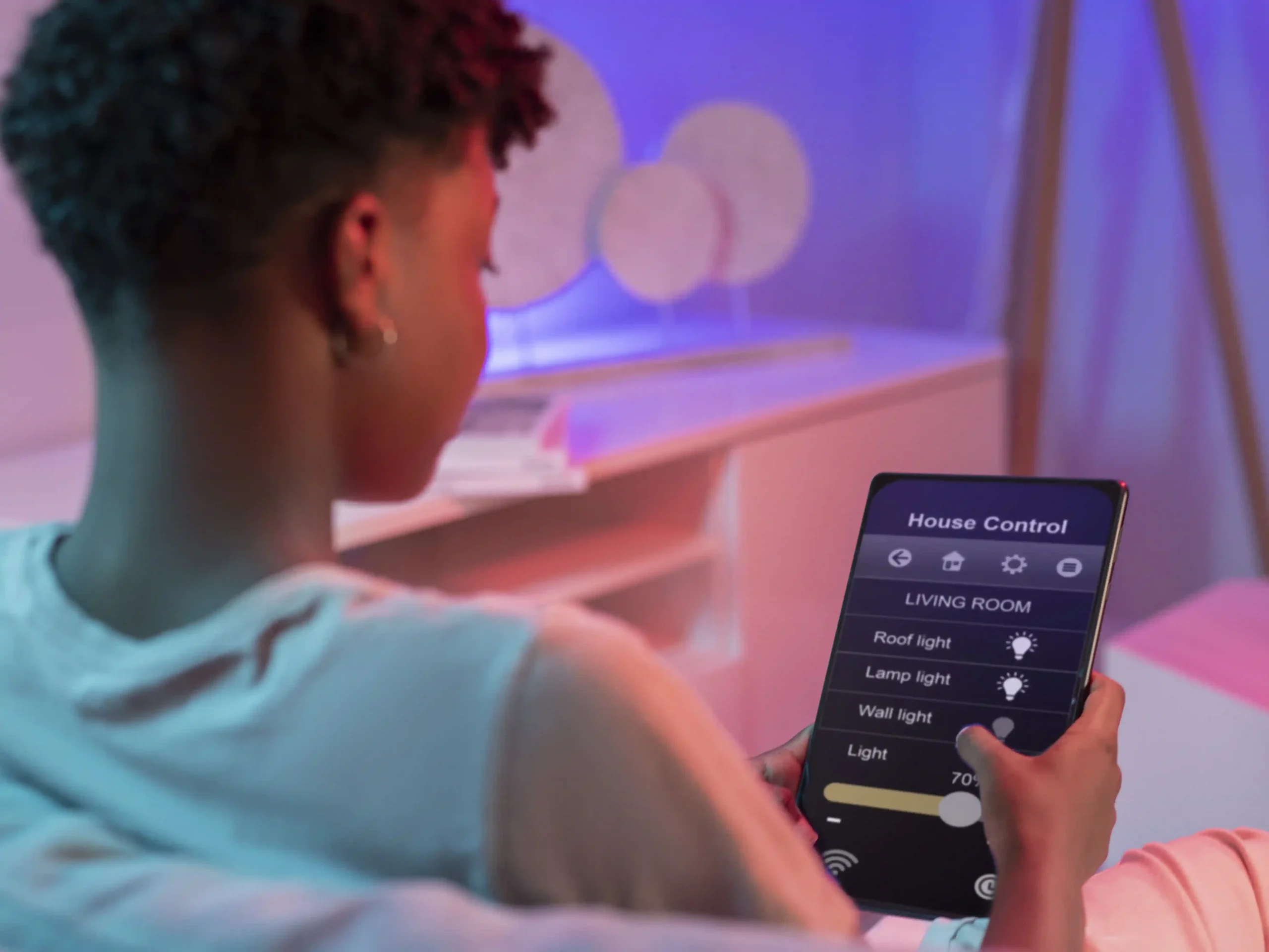 A-man-holds-a-tablet-focused-on-key-features-of-a-real-time-energy-monitor